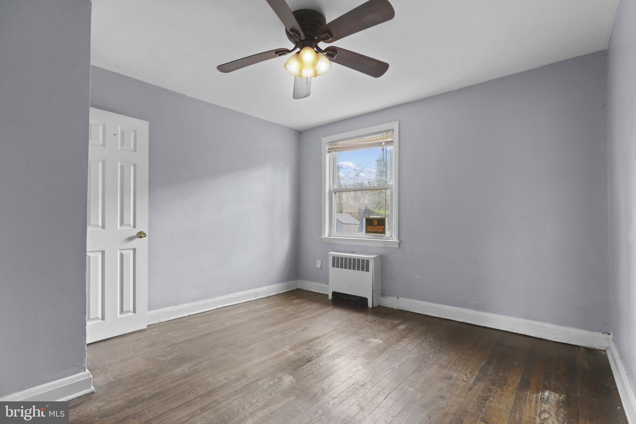 4511 Fairfax Road Baltimore, MD 21216 - Photo 17 of 35 wooden floor in an empty room with a window