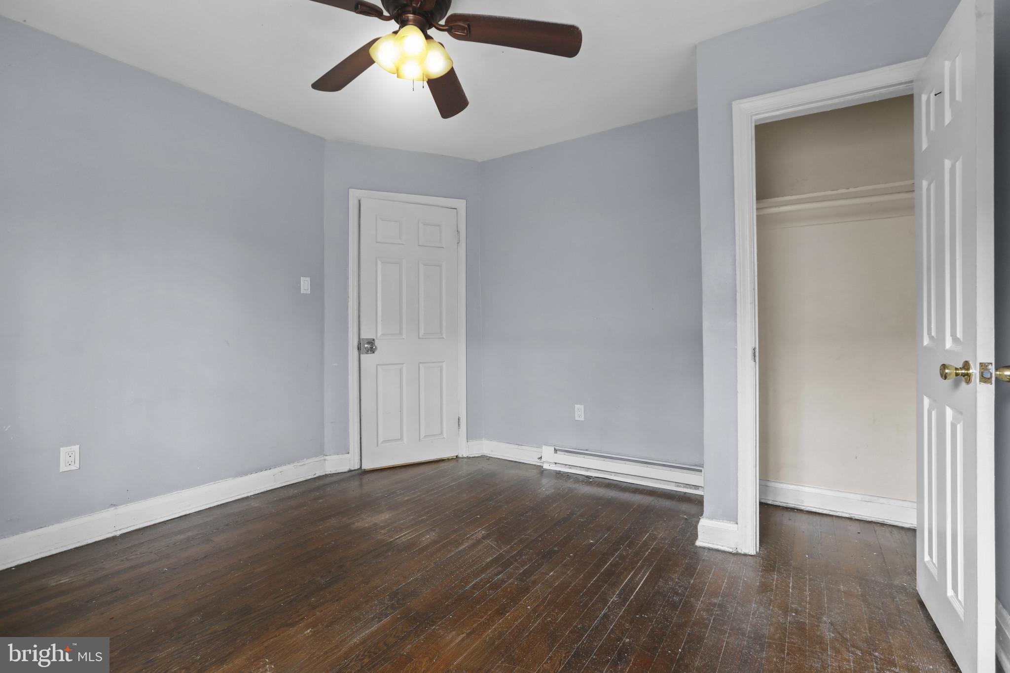 4511 Fairfax Road Baltimore, MD 21216 - Photo 18 of 35 an empty room with wooden floor cabinet and a ceiling fan