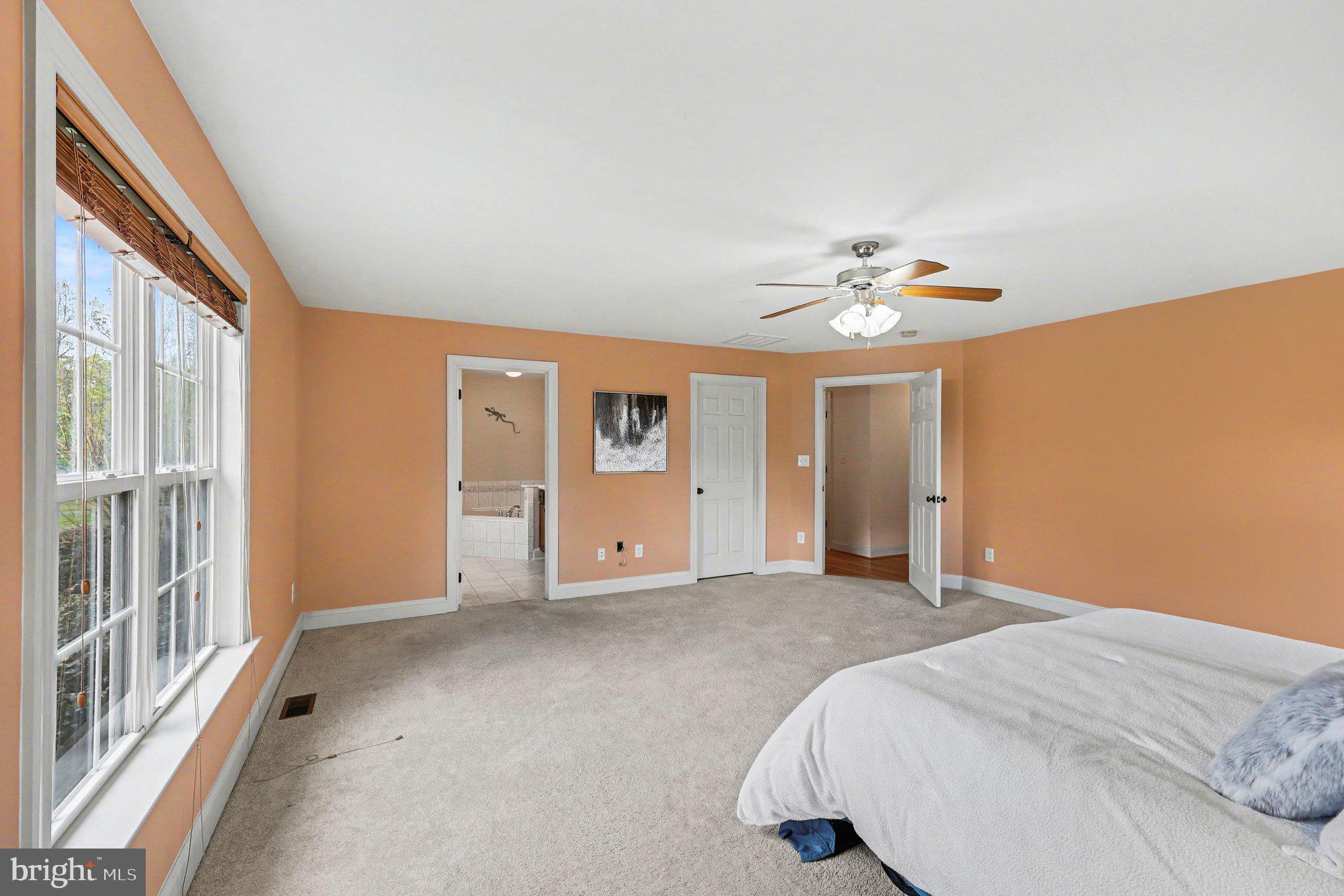 1564 Perry Road Winchester, VA 22602 - Photo 21 of 42 a bedroom with a bed and a chandelier