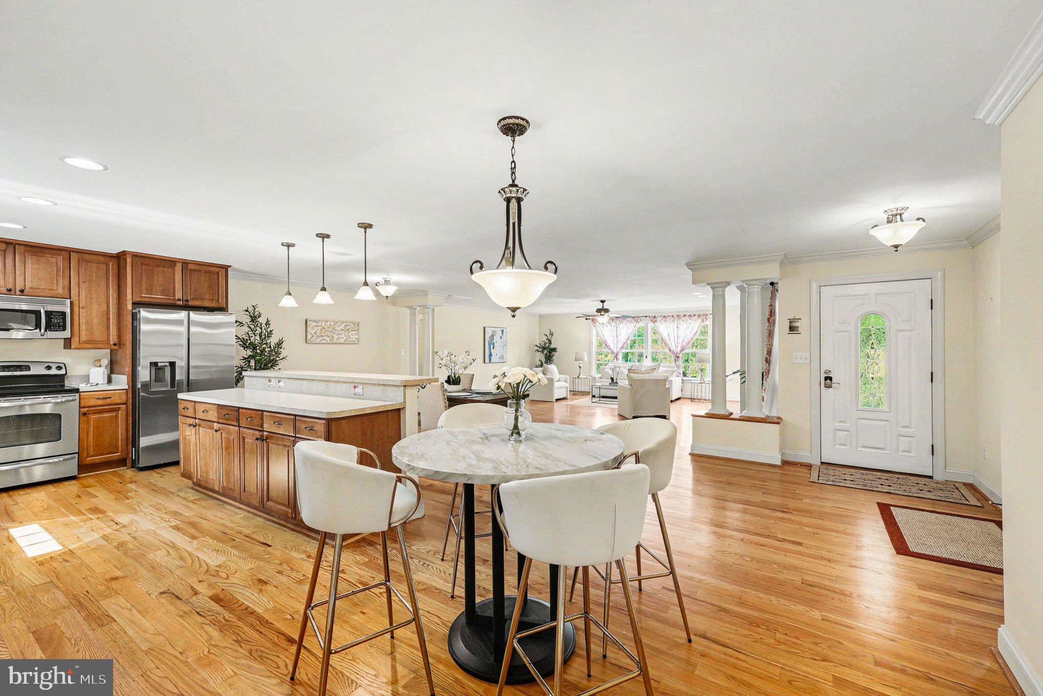 1564 Perry Road Winchester, VA 22602 - Photo 6 of 42 a dining hall with stainless steel appliances kitchen island granite countertop a dining table chairs and view living room