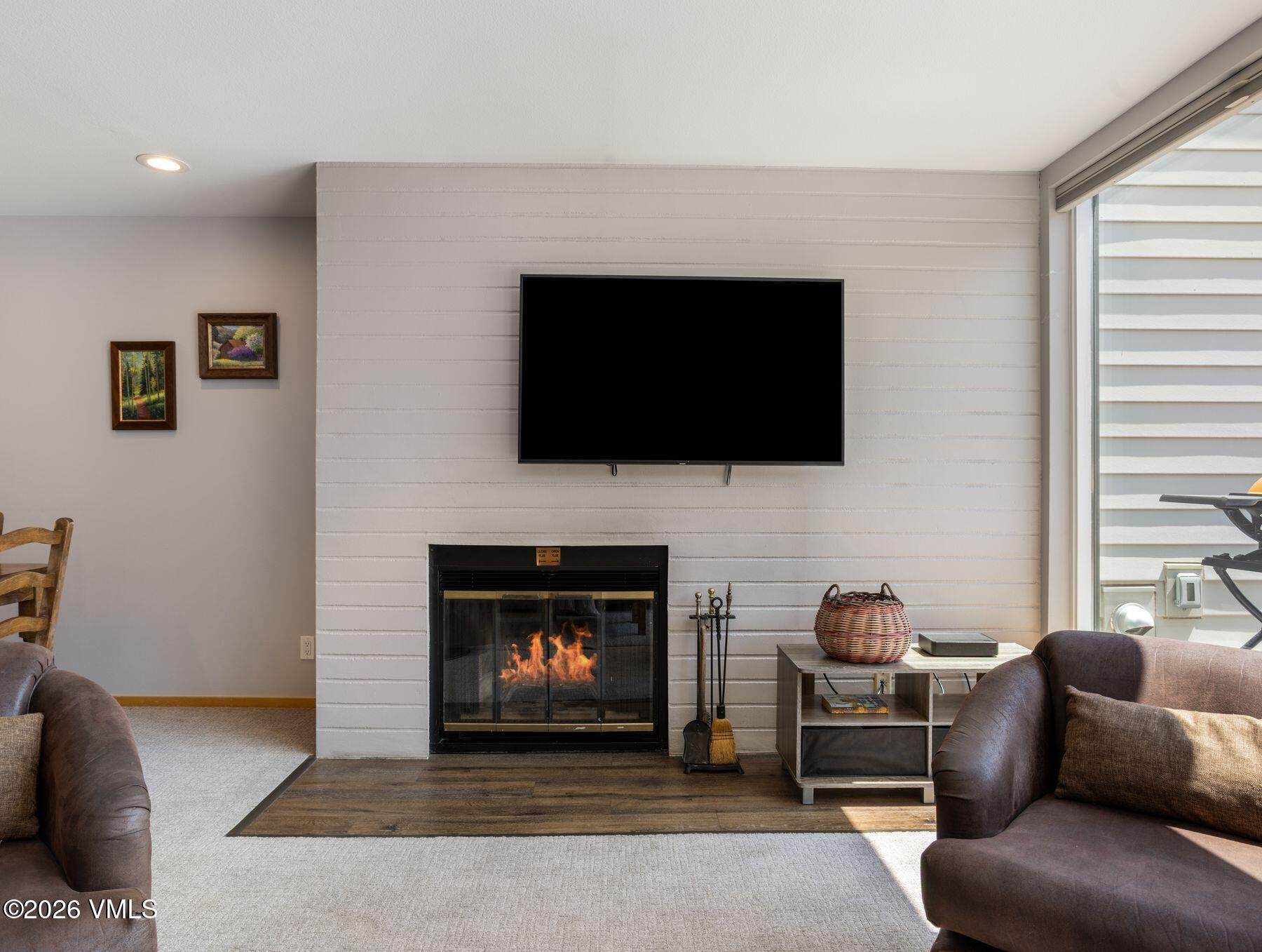 1100 North Frontage Road West, Unit 1503 Vail, CO 81657 - Photo 9 of 32 a living room with furniture a flat screen tv and a fireplace