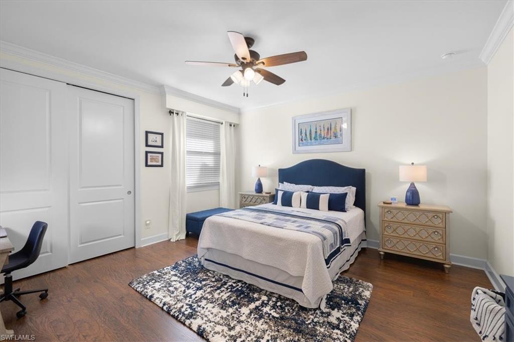 9684 Montelanico Loop, Unit 102 Naples, FL 34119 - Photo 18 of 24 a bedroom with a bed and a table