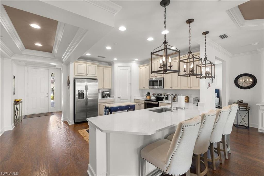 9684 Montelanico Loop, Unit 102 Naples, FL 34119 - Photo 2 of 24 a kitchen with refrigerator and cabinets