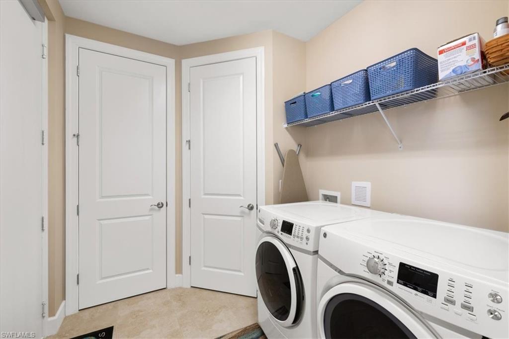 9684 Montelanico Loop, Unit 102 Naples, FL 34119 - Photo 21 of 24 a utility room with dryer and washer