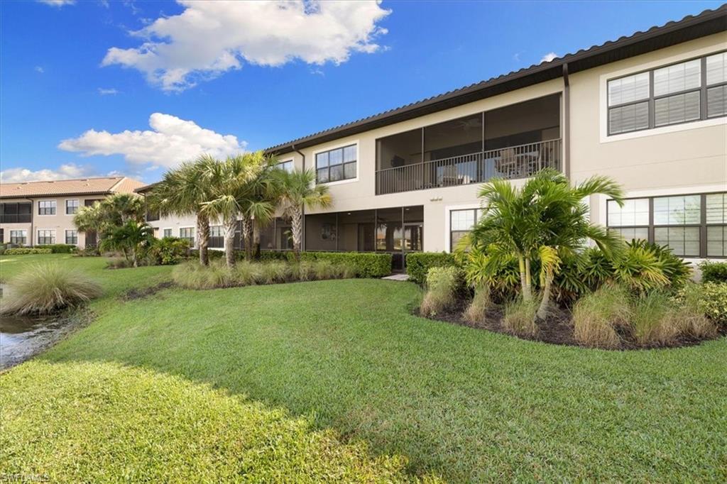 9684 Montelanico Loop, Unit 102 Naples, FL 34119 - Photo 24 of 24 a view of a house with a backyard
