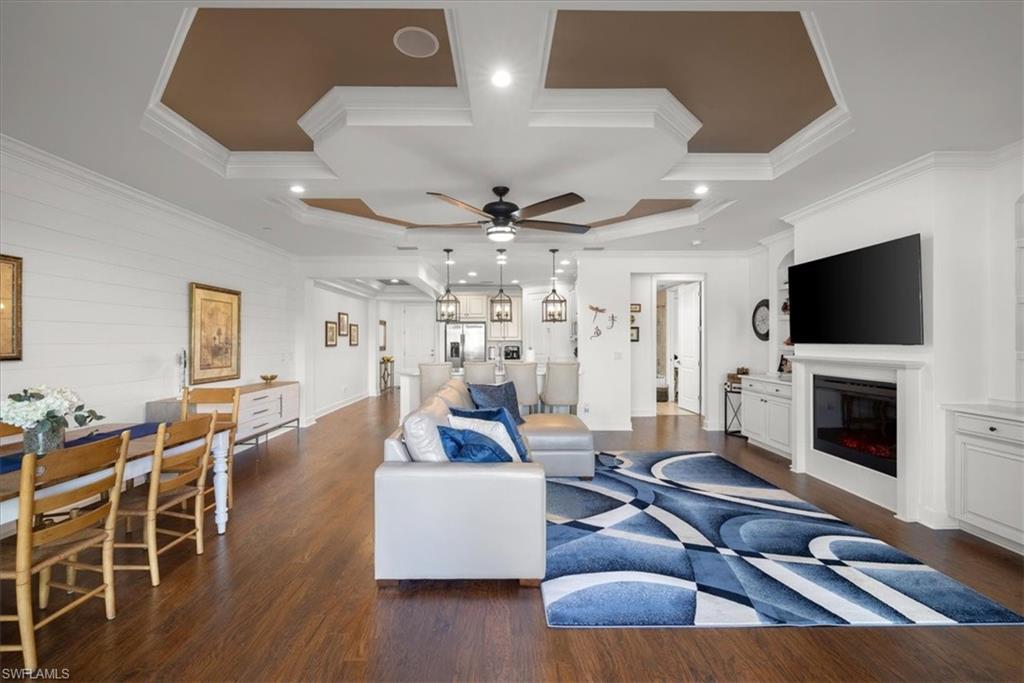 9684 Montelanico Loop, Unit 102 Naples, FL 34119 - Photo 7 of 24 a living room with furniture flat screen tv and a fireplace