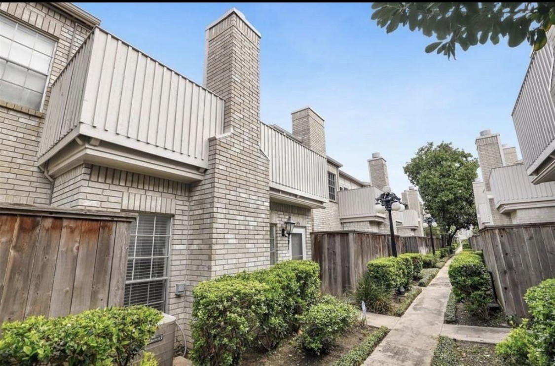 a view of a house with wooden fence