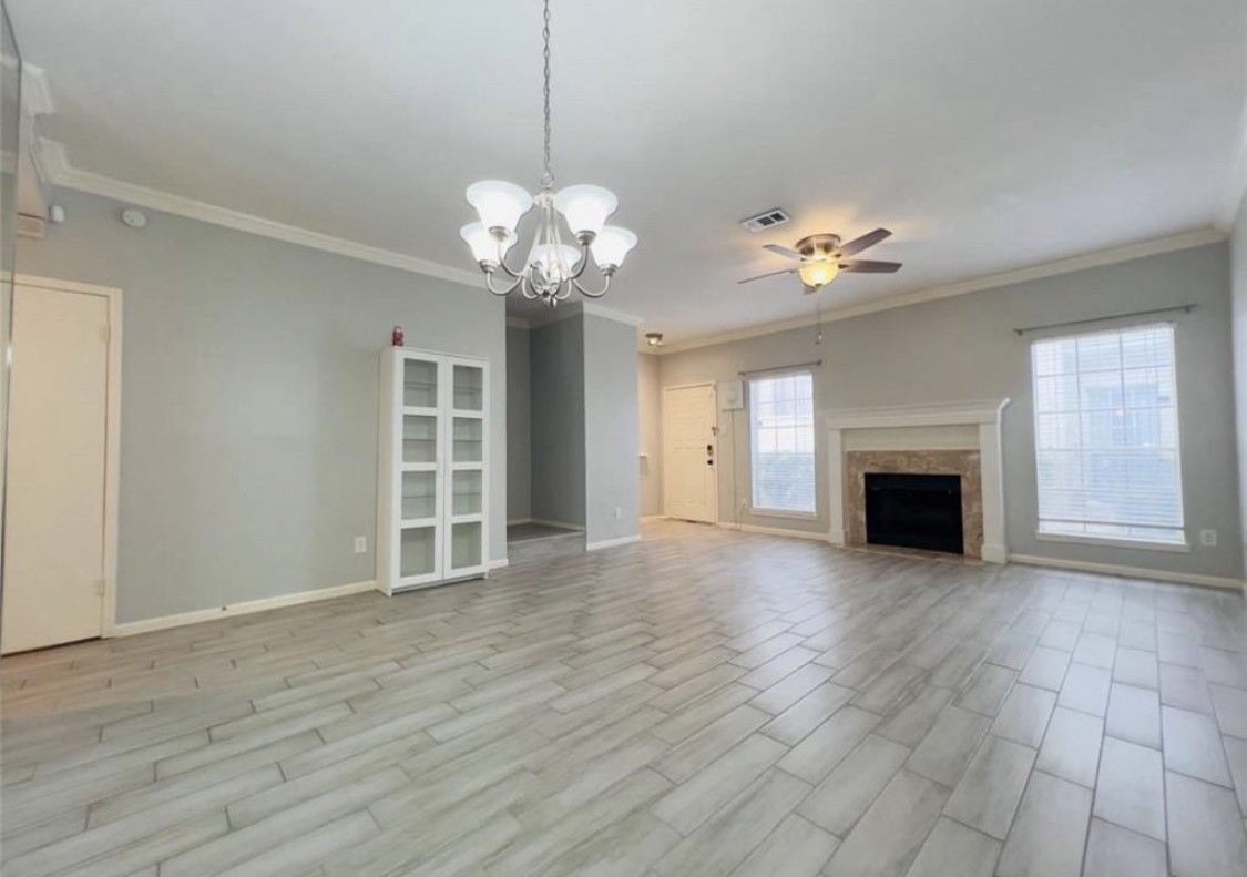3800 Tanglewilde Street West, Unit 806 Houston, TX 77063 - Photo 2 of 12 a view of a room with a chandelier and fireplace