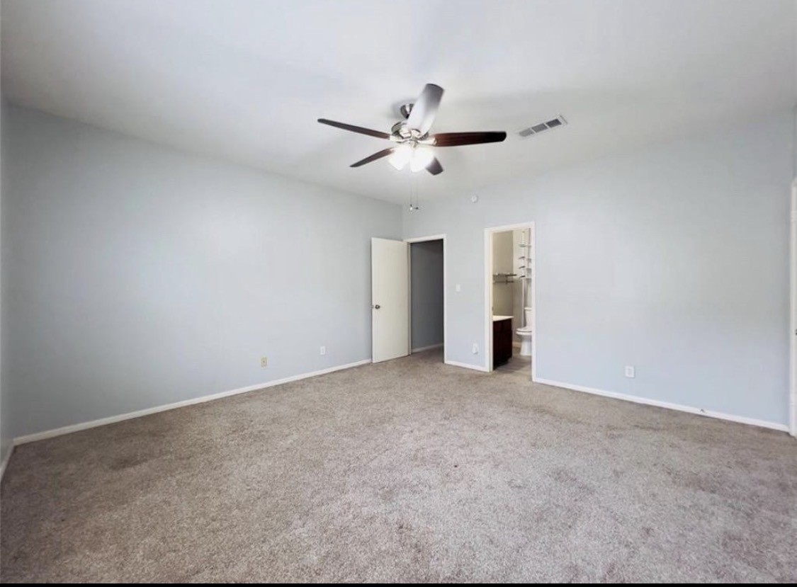 3800 Tanglewilde Street West, Unit 806 Houston, TX 77063 - Photo 8 of 12 a view of an empty room with a ceiling fan