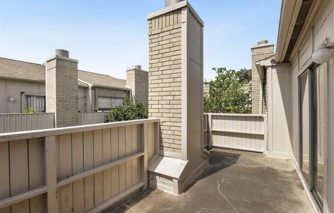 3800 Tanglewilde Street West, Unit 806 Houston, TX 77063 - Photo 10 of 12 a view of a balcony with a floor to ceiling window and wooden fence