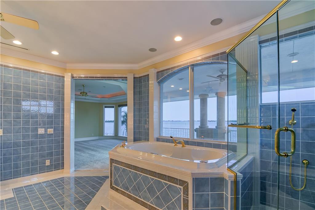 18 Island Road Stuart, FL 34996 - Photo 44 of 58 a spacious bathroom with a granite countertop sink and a mirror