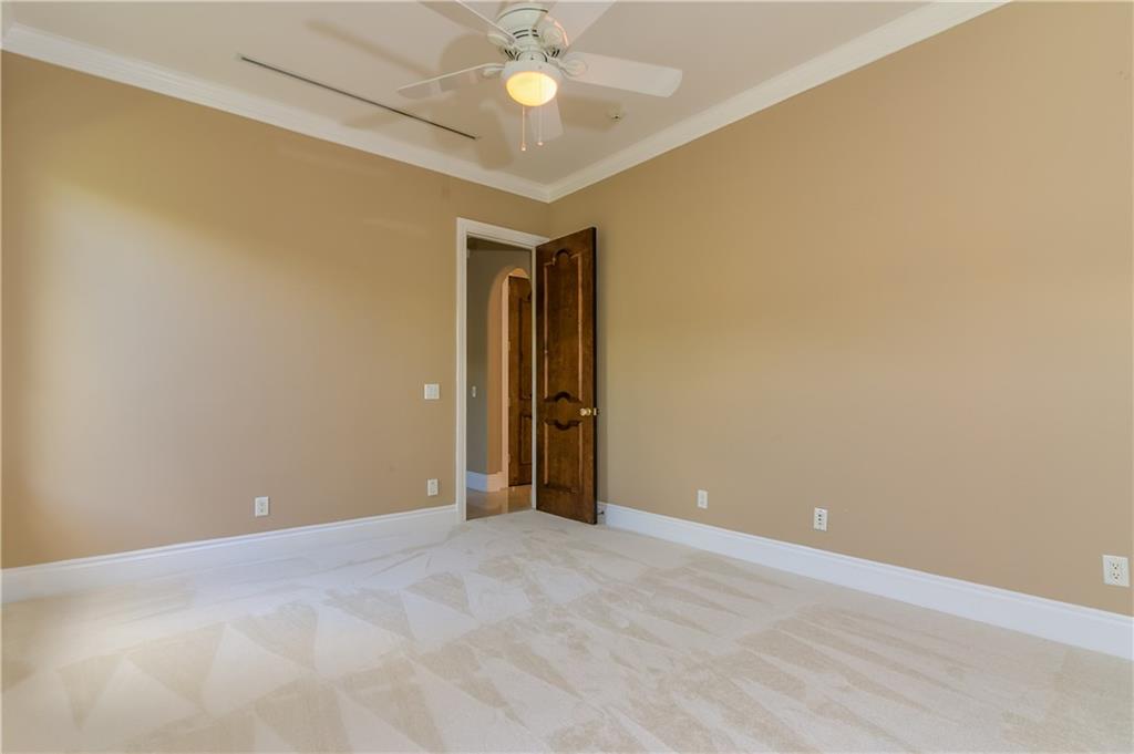 18 Island Road Stuart, FL 34996 - Photo 50 of 58 an empty room with a ceiling fan and carpet