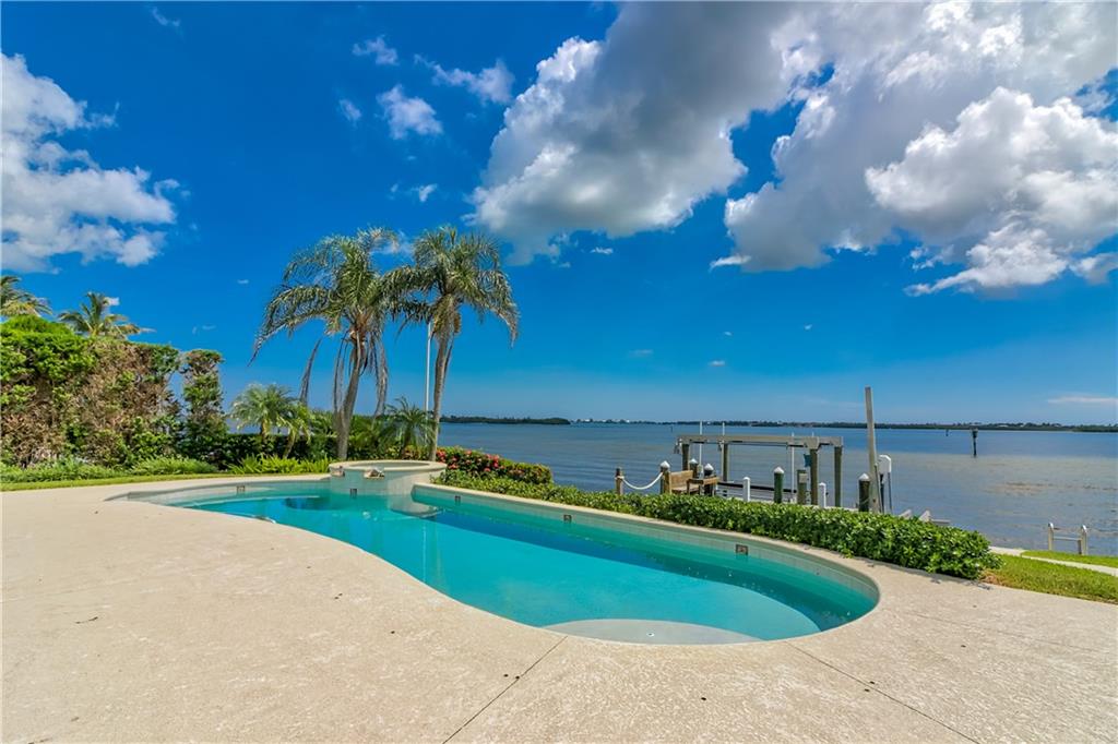 18 Island Road Stuart, FL 34996 - Photo 6 of 58 a view of a swimming pool and trees in the background