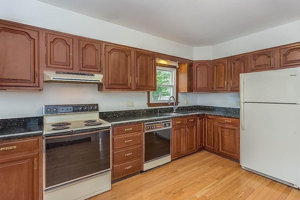 4 Hinds Road Winchester, MA 01890 - Photo 7 of 37 a kitchen with stainless steel appliances granite countertop a stove top oven a refrigerator and cabinets