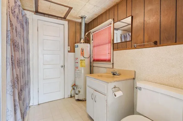 a bathroom with a sink toilet vanity and shower