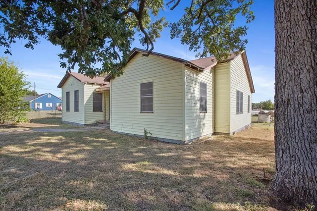 a view of a house with a tree in front