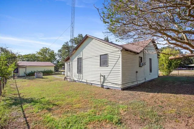 a view of a house with a yard and garage