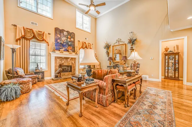 a living room with fireplace furniture and a rug