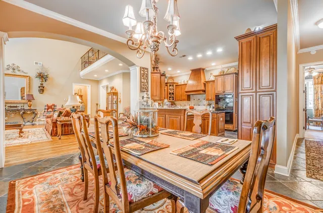 a view of a dining room with furniture and chandelier