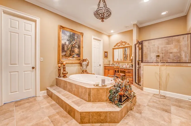 a spacious bathroom with a tub and shower