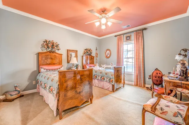 a spacious bedroom with a bed and a chandelier