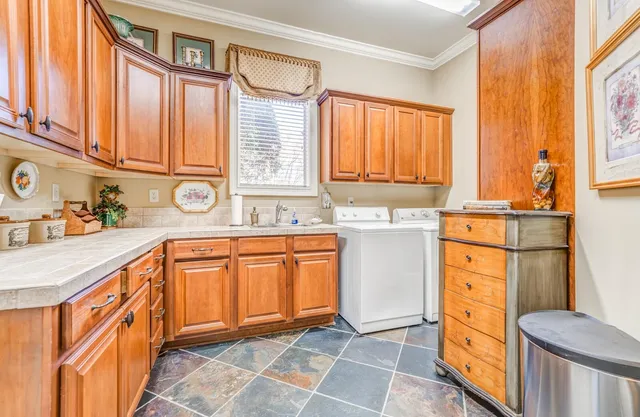 a kitchen with stainless steel appliances granite countertop a sink and a refrigerator