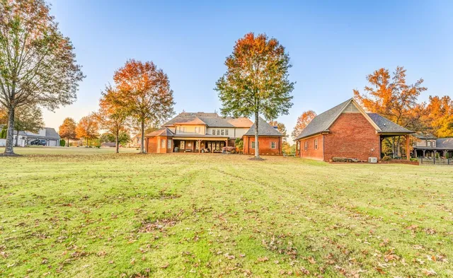 a yellow house with trees in front of it
