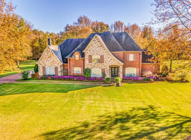 a view of a house with a swimming pool and a yard