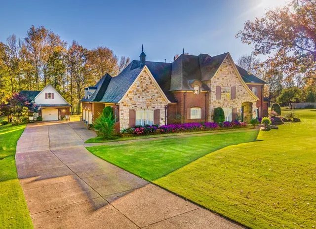 a front view of house with yard and green space