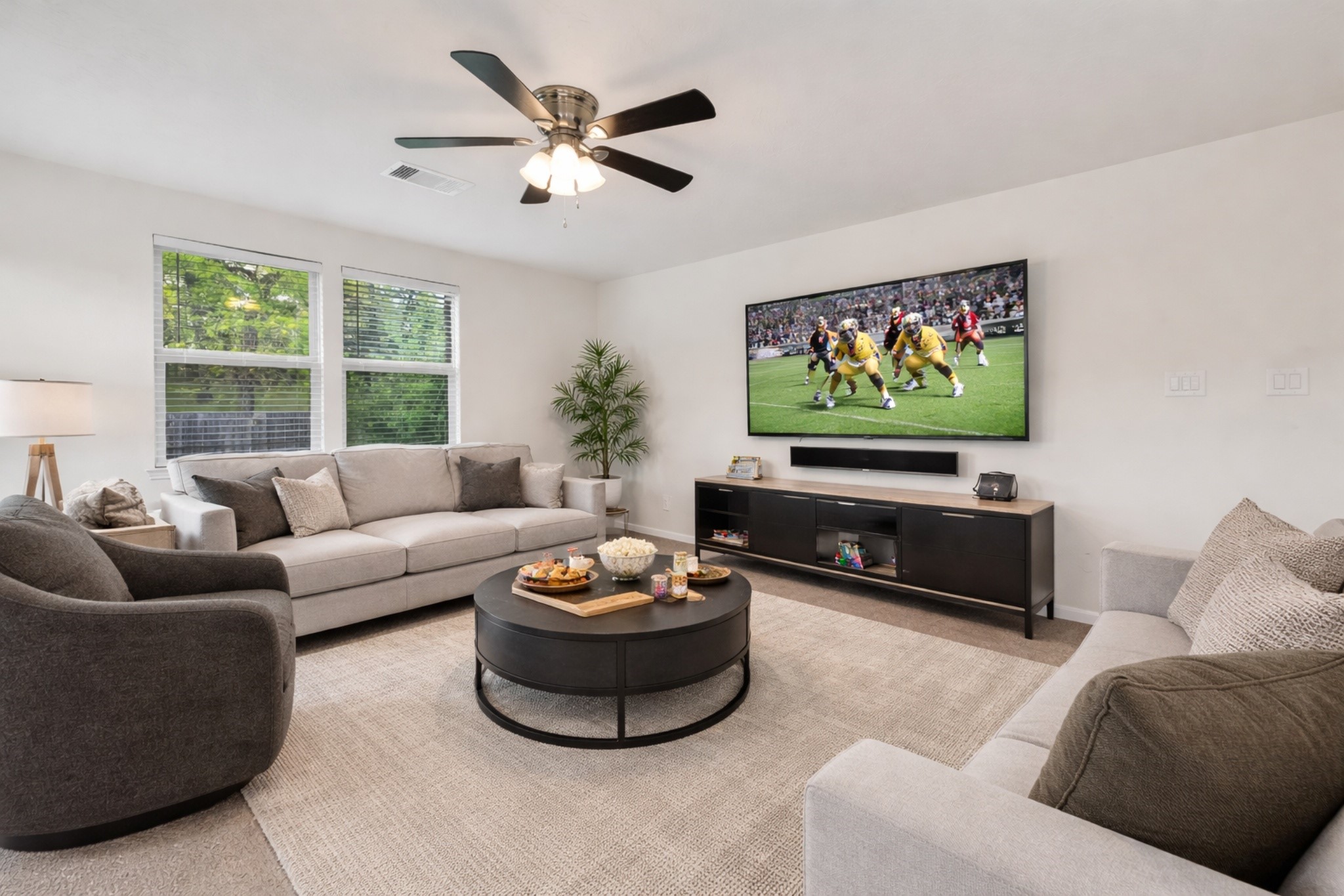 2107 Parnevik Place Conroe, TX 77304 - Photo 20 of 44 Remember, you can easily close the 2'' blinds if all of these windows are putting a glare on your movie screen. Isn't this a perfect space to gather for family fun and entertainment?! digitally enhanced