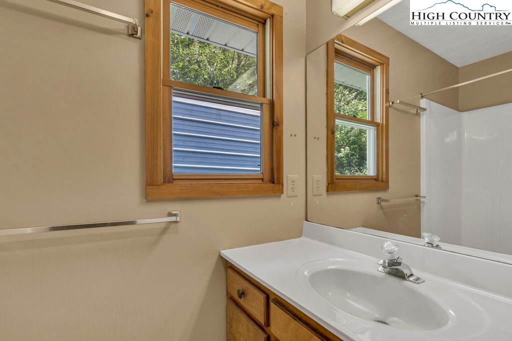 450 Astor Cook Road Blowing Rock, NC 28605 - Photo 15 of 39 a bathroom with a sink and a mirror