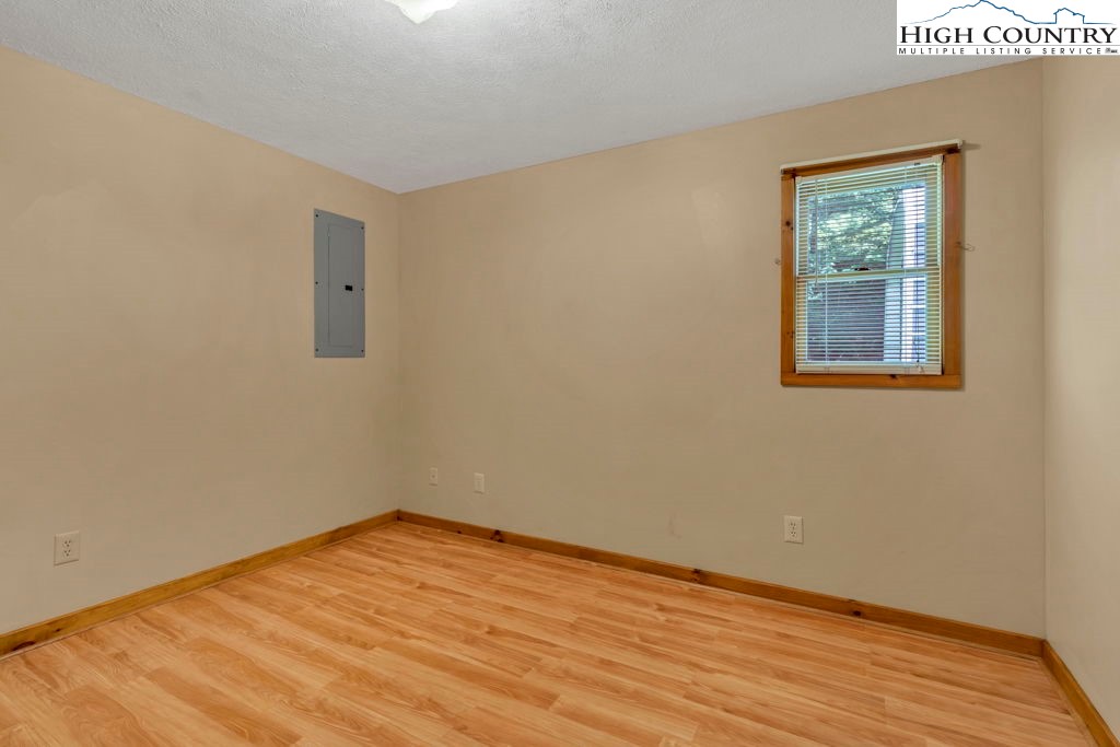 450 Astor Cook Road Blowing Rock, NC 28605 - Photo 17 of 39 a view of an empty room with wooden floor and a window