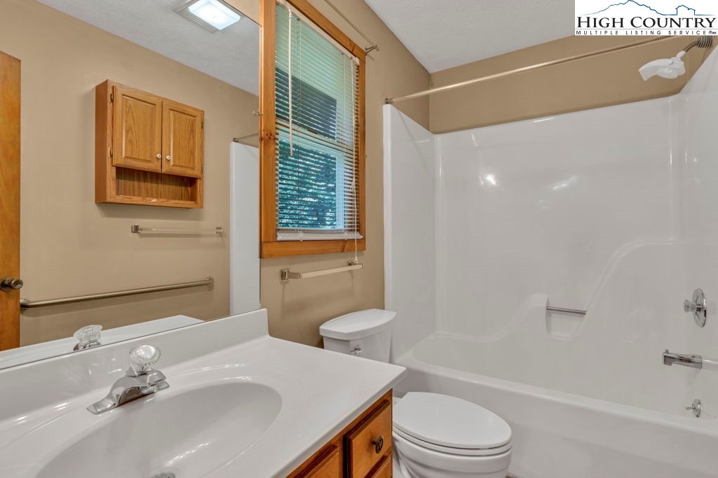 450 Astor Cook Road Blowing Rock, NC 28605 - Photo 18 of 39 a bathroom with a sink toilet tub and shower