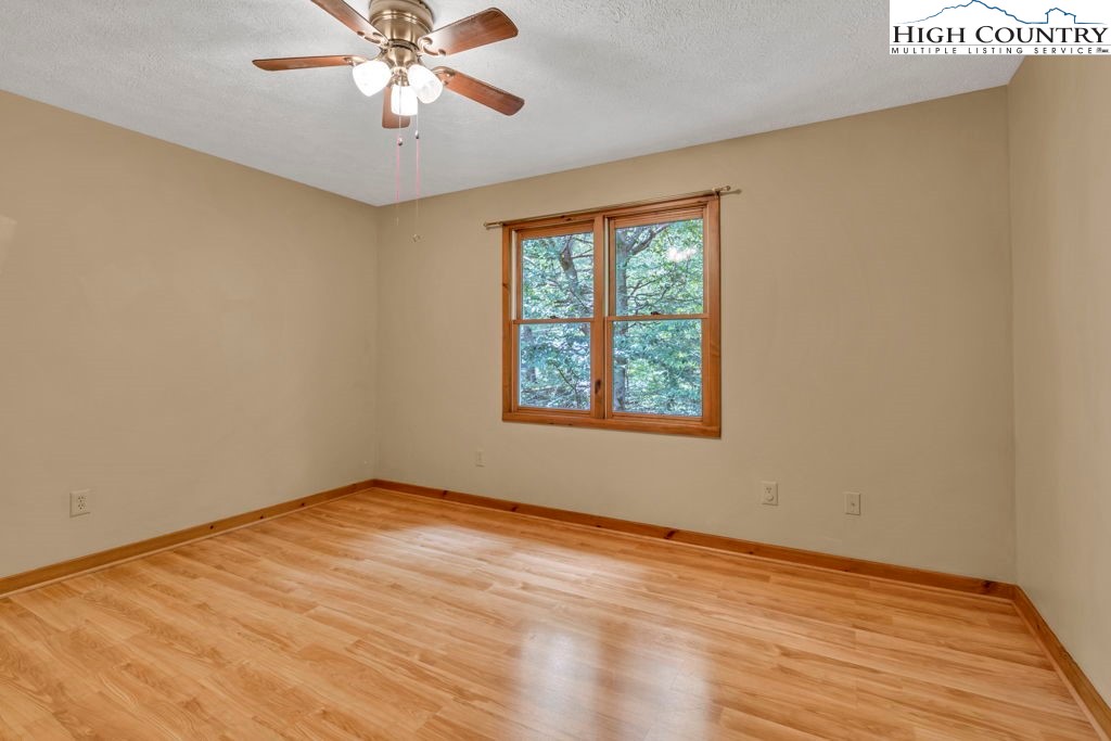 450 Astor Cook Road Blowing Rock, NC 28605 - Photo 19 of 39 an empty room with a window and a ceiling fan
