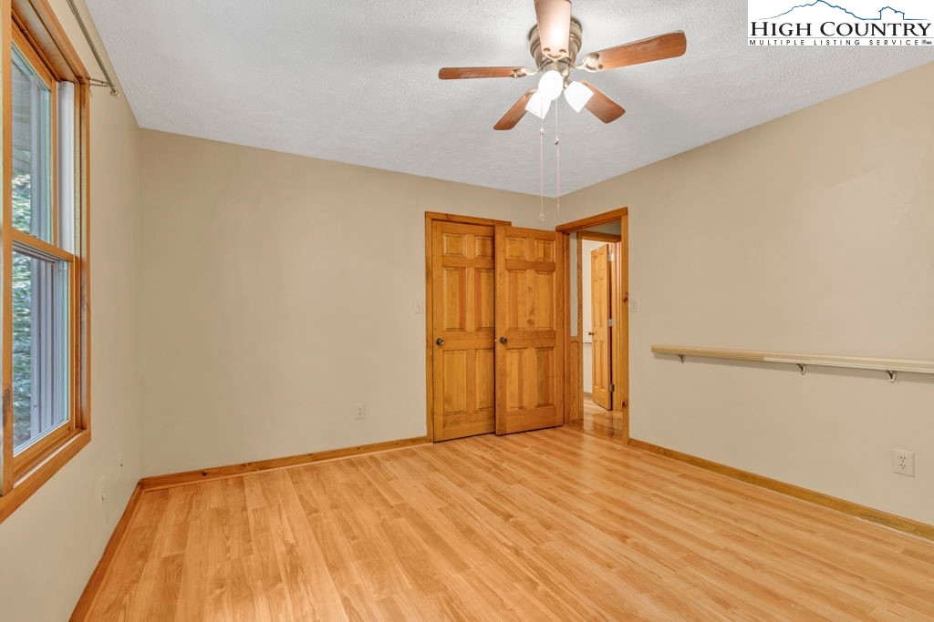 450 Astor Cook Road Blowing Rock, NC 28605 - Photo 20 of 39 a view of empty room with wooden floor and fan