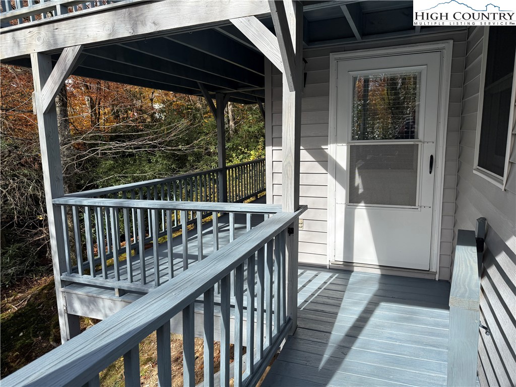 450 Astor Cook Road Blowing Rock, NC 28605 - Photo 22 of 39 a view of a balcony with wooden floor and fence