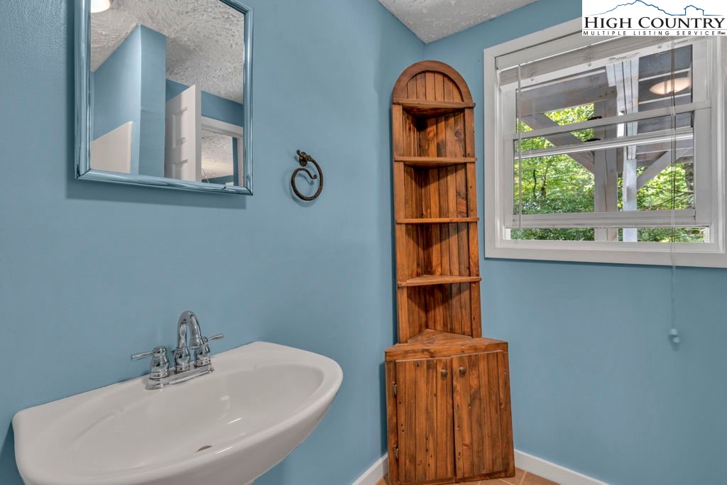 450 Astor Cook Road Blowing Rock, NC 28605 - Photo 26 of 39 a bathroom with a sink and a mirror