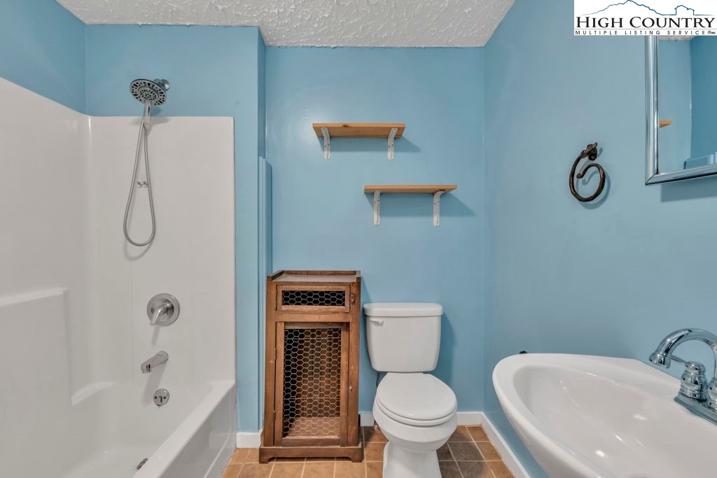 450 Astor Cook Road Blowing Rock, NC 28605 - Photo 30 of 39 a white toilet sitting next to a bath tub