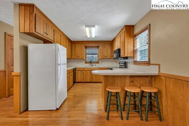 a kitchen with stainless steel appliances granite countertop a sink stove and microwave