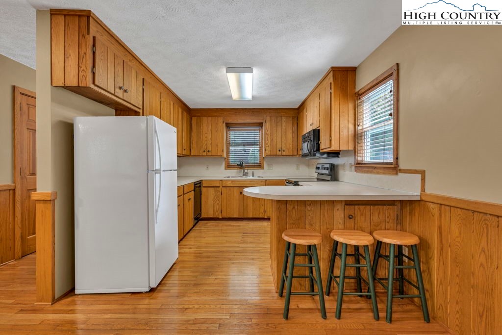 450 Astor Cook Road Blowing Rock, NC 28605 - Photo 7 of 39 a kitchen with stainless steel appliances granite countertop a refrigerator and a stove top oven