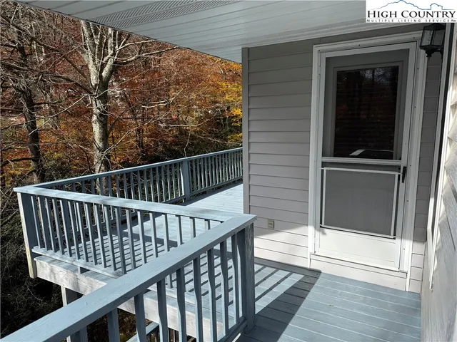 a balcony with wooden floor and fence