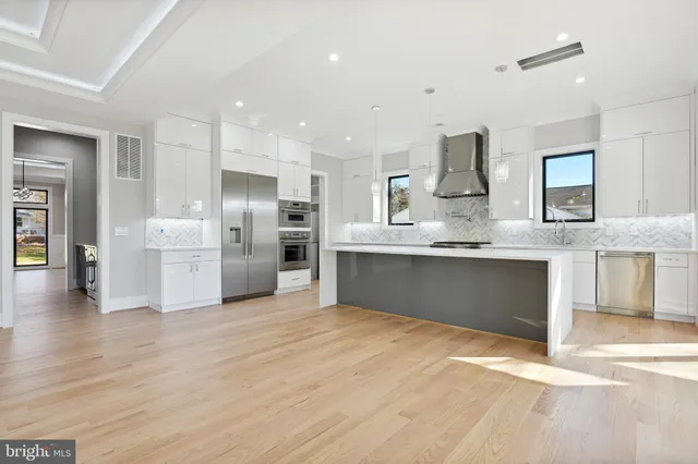 an empty room with kitchen and fireplace