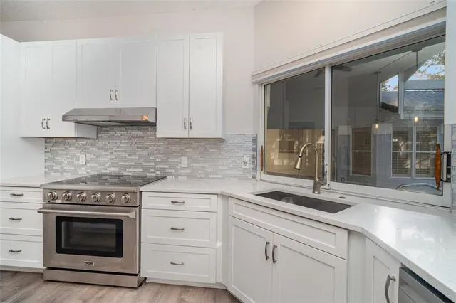 a kitchen with granite countertop a stove and a sink