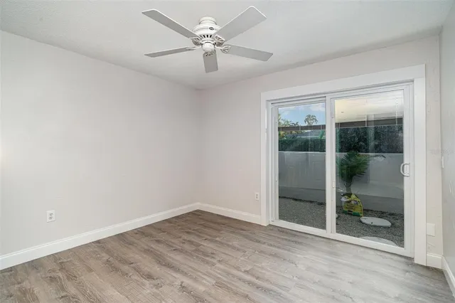 a view of empty room with wooden floor and cabinet