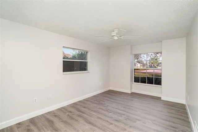 a view of an empty room with wooden floor