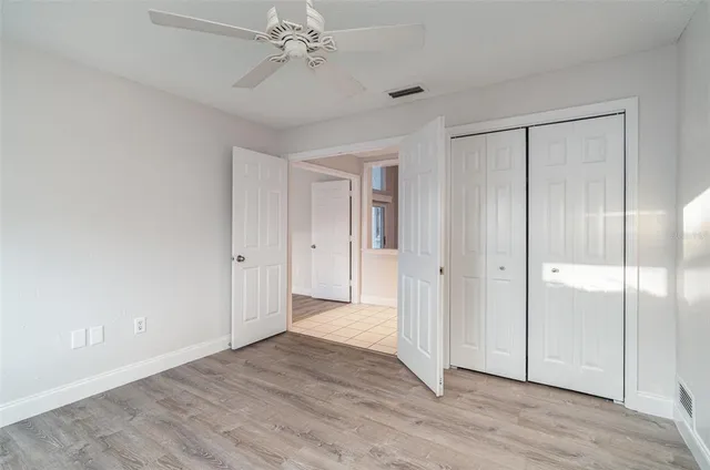 a spacious bathroom with a granite countertop sink and a mirror