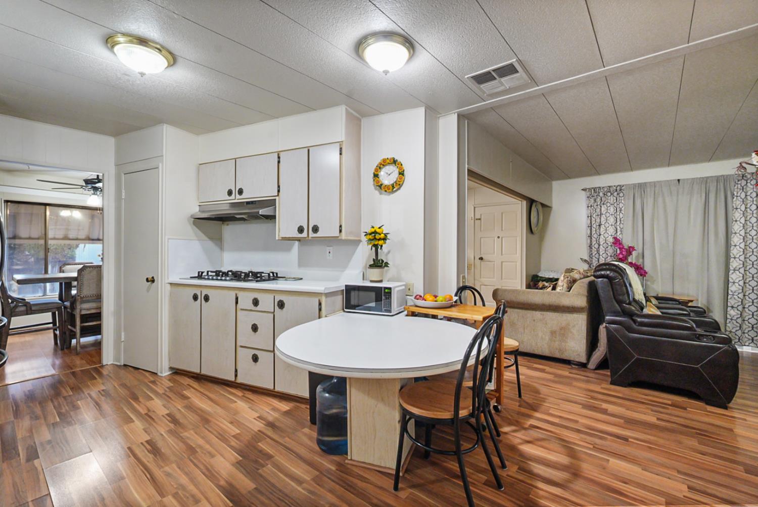 2845 East Hatch Road, Unit 84 Ceres, CA 95351 - Photo 12 of 39 a very nice looking kitchen with a table chairs and a refrigerator