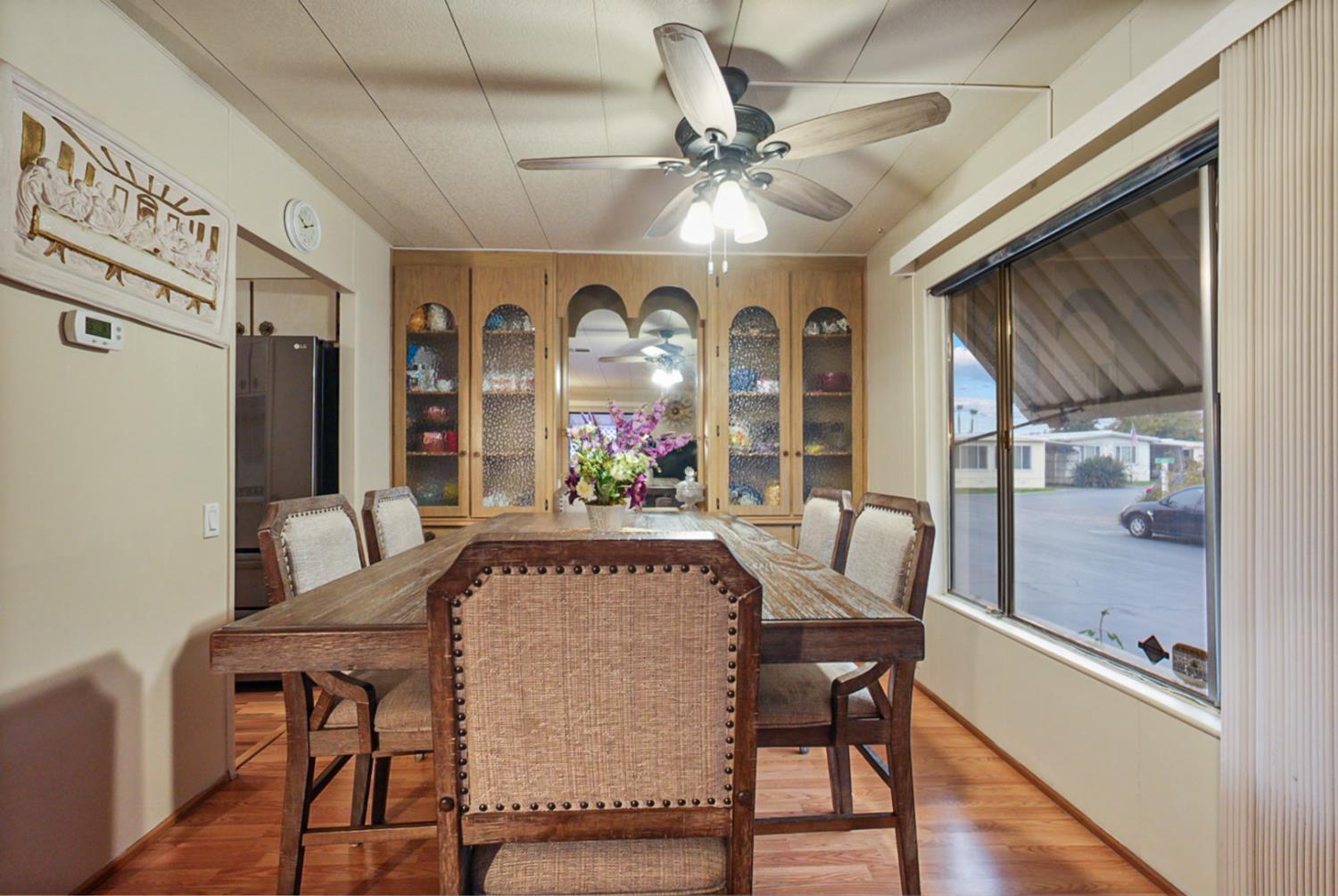 2845 East Hatch Road, Unit 84 Ceres, CA 95351 - Photo 15 of 39 a view of a dining room with furniture window and wooden floor