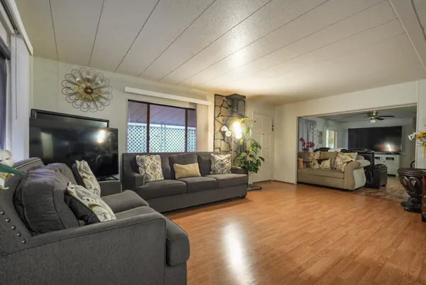 a living room with furniture and wooden floor