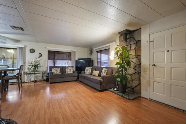 a bedroom with a bed dresser and a flat tv screen